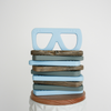 Stack of 4 glasses shaped teething toys. Top one is light blue color and standing up 