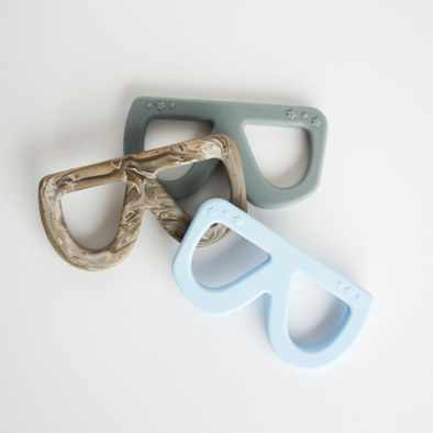 Three glasses shaped teething toys in a pile