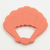 Coral seashell teether, white background. 