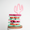 Cactus shaped teething toys stacked in multi colors. Top one is taffy pink and is standing 