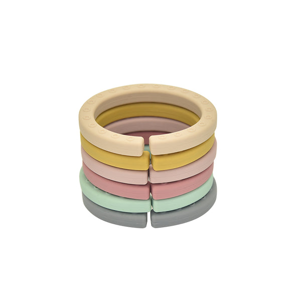 Stack of six link rings, one of each color. White background. 