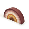 Silicone rainbow stacker . White background. Muted brown, tans, oranges, pinks. 