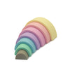 Pastel rainbow stacker. Seven pieces. White background. 