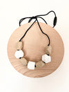 Harper teething necklace. Beige and taupe rock shaped silicone beads on a necklace. 