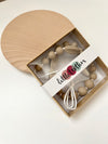 Taupe silicone beaded teething necklace inside clear-front box packaging