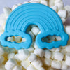 Cyan blue rainbow Teether. Marshmallow cloud background. 