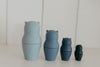 4 silicone bears each a different shade of blue from left to right tallest to shortest