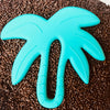 Tropical palm tree silicone Teether with brown sprinkle background 
